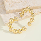 Women's Bracelet with Structured, Golden Beads