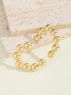 Women's Bracelet with Structured, Golden Beads