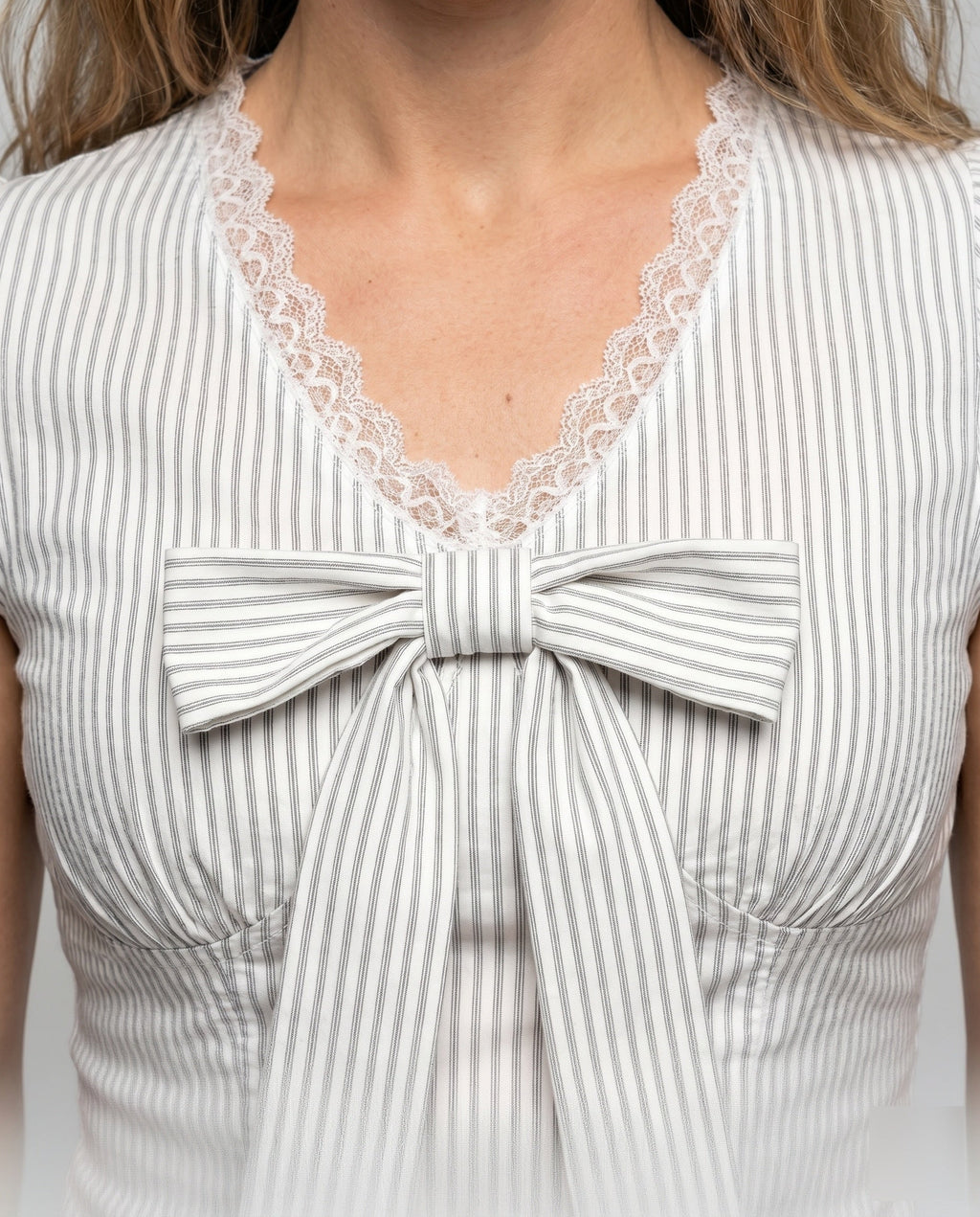 Women's Blouse Shirt with Playful Bow Design and Ruffle Hem - Close-Up Detail