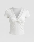 Women's Top with Elegant Lace Decoration and Playful Knot Detail