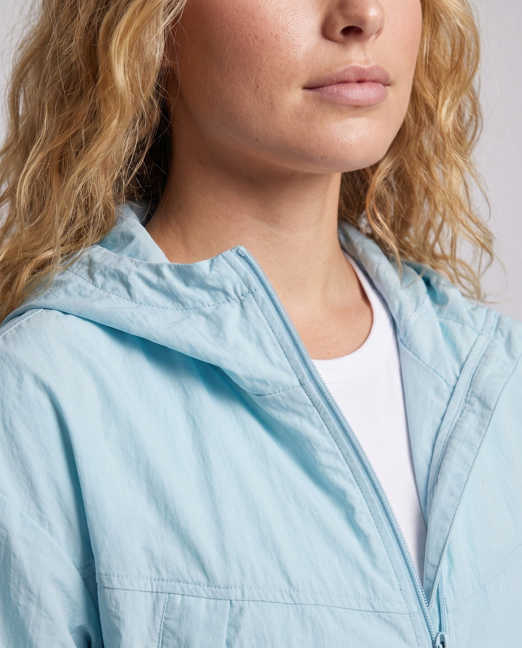 Women's Lightweight Outdoor Jacket with Packable Hood Design - Close-Up Detail