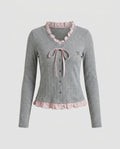 Women's long sleeve blouse with playful ruffled hem and decorative loop design - Chichicherry